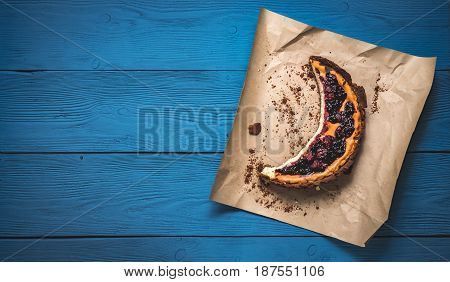 Top View Of Cheesecake On The Kraft Paper On The Blue Boards