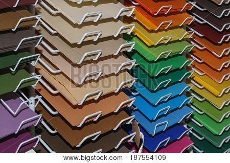 Drawing colored paper for pastels close-up on the shelves in the art supplies shop for the artist