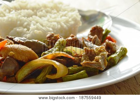 stir fried chicken and mixed entrails with sweet chili eat couple with rice on plate