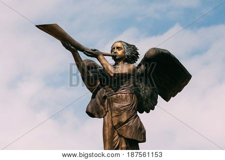 Vilnius, Lithuania. Statue Of An Angel Blowing A Trumpet In Main Square Against A Sunny Blue Sky In Uzupis District. Uzupio Republic Or Uzupis Is A Cultural Artistic District, Popular Tourist Place