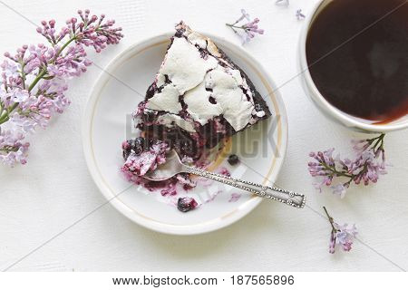 Tender homemade baking blueberry pie with lilac and tea