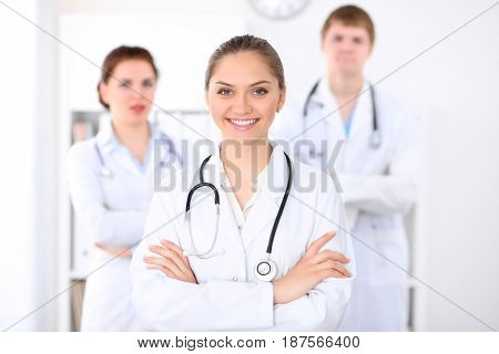 Happy doctor woman with medical staff at the hospital.