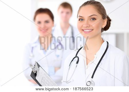 Happy doctor woman with medical staff at the hospital.