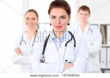 Happy doctor woman with medical staff at the hospital.