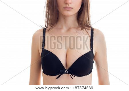 young girl with big sexual natural breasts in black lingerie close-up isolated on white background