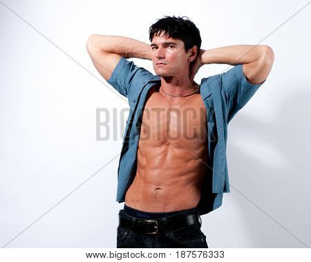 The macho man is showing off his hot body.