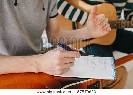 Learning to play the guitar. Music education and extracurricular lessons. Guitarist