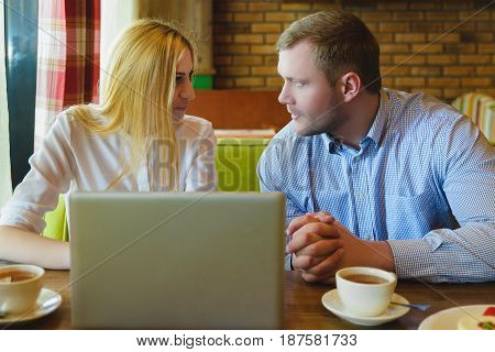 Business meeting in a cafe. Man and woman are negotiating.