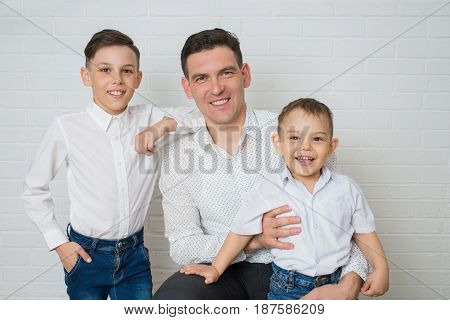 Happy Father and two Sons. Fathers day. Studio portrait over white background