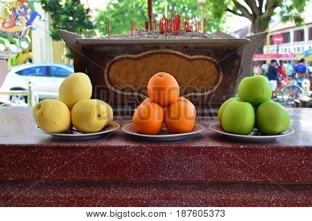Fruits offering as a sacrifice at Chinese temple yellow pear orange and green apple