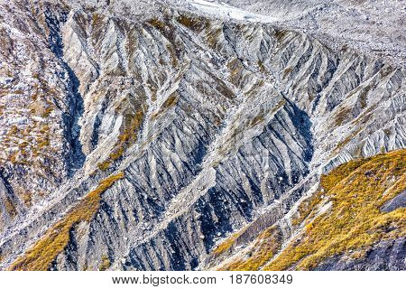 Aerial view of Alaska mountains glacier ridges texture. Closeup of rock sediments on mountain ridges, wilderness nature travel adventure.