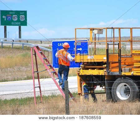 JULY 15, 2012.  CASPER, WY.  Highway crew working and repairing sign on the interstate in Casper, Wy.