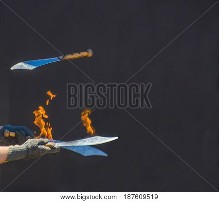 Fire on knives while and being juggled