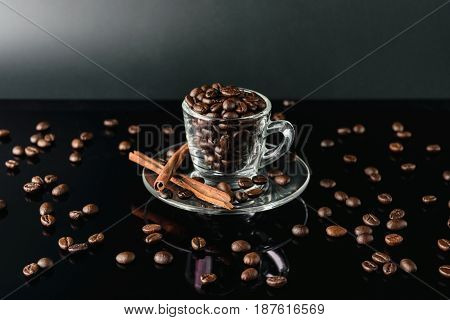 close up coffee bean in cup glass dark background
