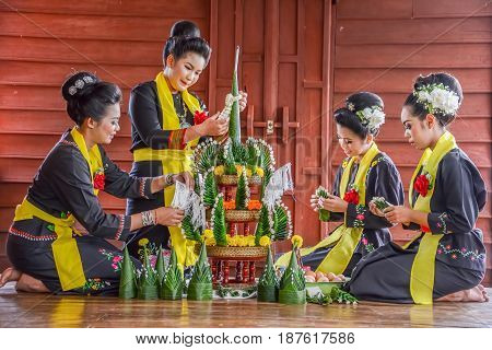 NAKORN PHANOM THAILAND - FEBRUARY 14 2015: Thai northeastern Phutai traditional liftstyle in making rice offering and garland for Phutai world cerebration event in Renunakorn of Nakorn Phanom Thailand.