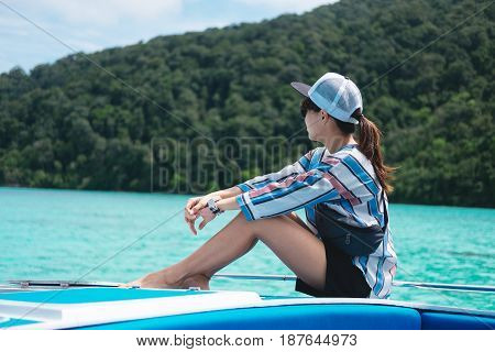 Side View. Asia Woman Sitting Alone On Prow And Looking Scenery Sea View With Green Forest On Island