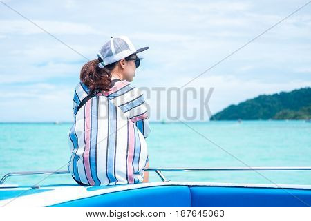 Back View. Asia Woman Sitting On Prow And Looking Scenery Sea View On Front Of Her. Have Island Are