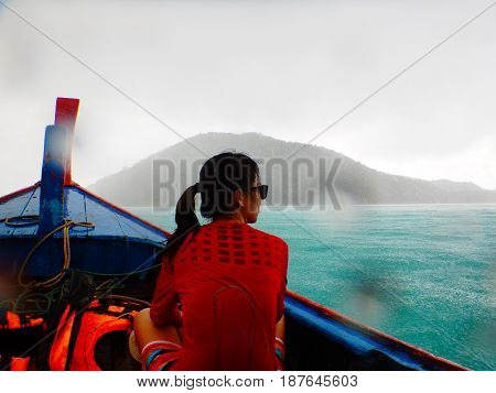 Asia Woman Wearing Red Shirt Sitting On Longtail Boat While Rainy Makes Herself Wet Moist. Have Sea