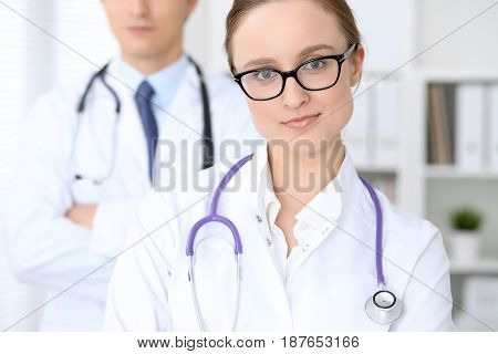 Happy doctor woman with medical staff at the hospital.