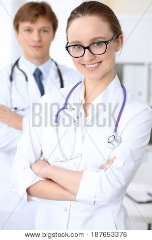 Happy doctor woman with medical staff at the hospital.