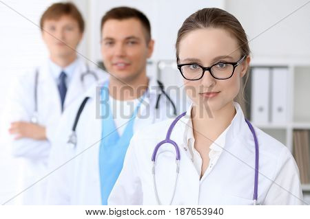 Happy doctor woman with medical staff at the hospital.