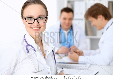 Happy doctor woman with medical staff at the hospital.