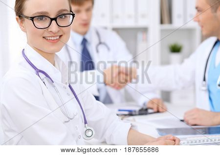 Happy doctor woman with medical staff at the hospital.
