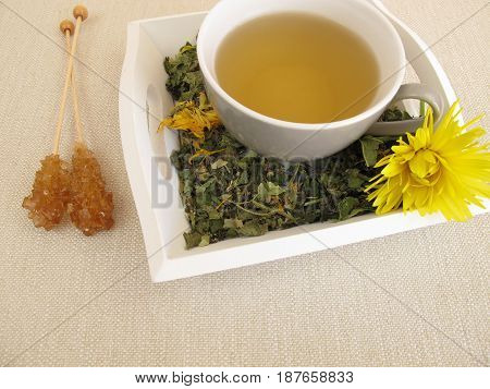 Herbal tea with marigold and cornflower on tray