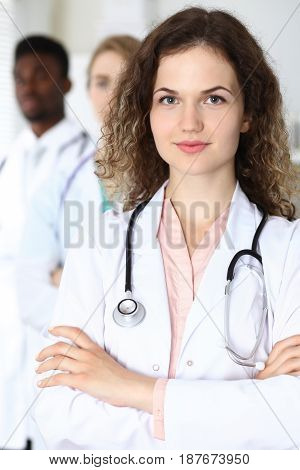 Happy doctor woman with medical staff at the hospital.