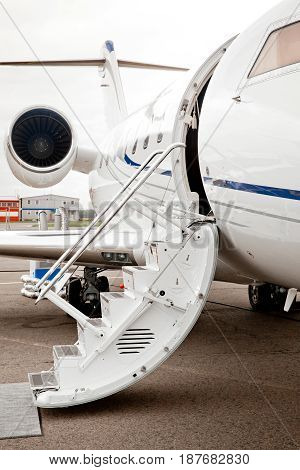 Ladder trap and open door to business jet airplane