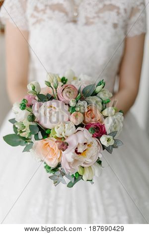Soft and tender bridal bouquet of roses and peonies
