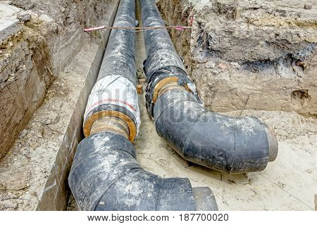 View of unfinished diverting new pipeline in trench.