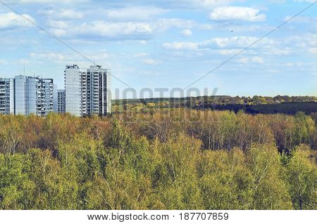 View of the high panel dwelling houses surrounded by dense forest
