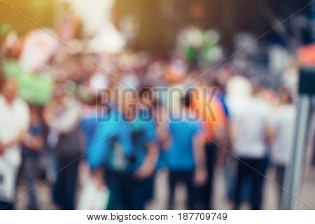 Blur defocussed crowd of people at public place such as street abstract background for general public or population opinion concept