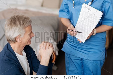 For your consideration. Lovely wonderful caring doctor demonstrating some data and making sure elderly gentleman understanding all terms of his treatment
