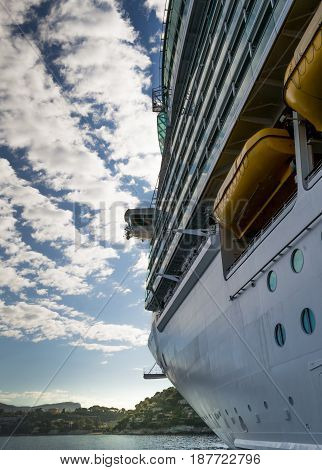 Port side of a giant cruise chip anchored in the Mediterranean Sea near to the coast