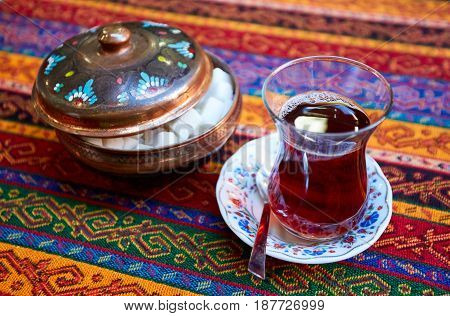 Thr black turkish tea in traditional glass.