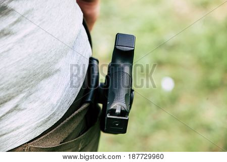 Pistol in the holster. The shooter trains. Is preparing to shoot at the target.