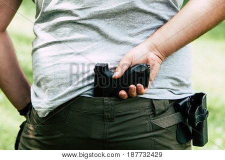 Pistol in the holster. The shooter trains. Is preparing to shoot at the target.
