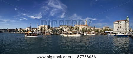 Split view on south part of old town behind sea and boats are Diocletian's palace and St Domnius cathedral