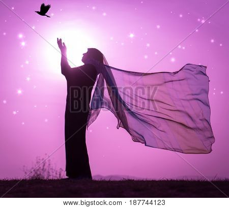  Copy space of silhouette woman rising hands on sunset sky double exposure colorful bokeh and bird fly background. Vintage tone filter effect color style.