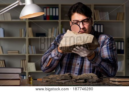 Archeologist working late night in office