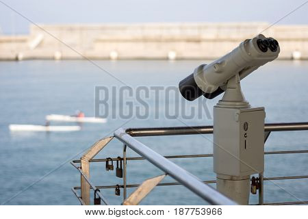 Binoculars Pointing Out to Sea and Sailing