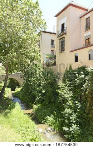 Brick bridge over the river Darro in Granada Andalusia Spain.