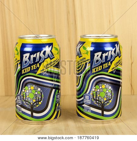 RIVER FALLS,WISCONSIN-MAY 22,2017: Two cans of Brisk brand iced tea with a wood background.