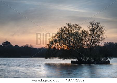 Beautiful Vibrant Spring Sunrise Over Calm Lake In English Countryside