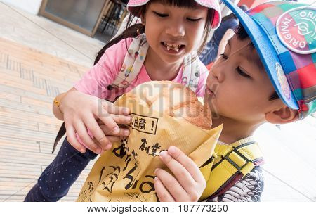 Tokyo Japan - May 1 2017: Asian Kids is eating Asakusa's Famous Melonpan bread.
