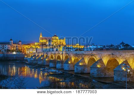 The Roman bridge and Guadalquivir river in the Historic centre of Cordoba Andalusia Spain. Evening