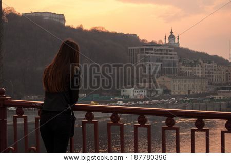 Silhouette of Little girl and mother are fishing at the Bottom view of Bridge. Sunset at Akashi Kaikyo Bridge suspension bridge spanning the Seto Inland Sea from Awaji Island to Kobe Japan