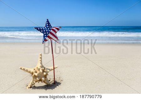 Patriotic USA background with starfish decorations on the sandy beach
